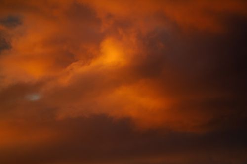 Free A vibrant and dramatic fiery orange sky with clouds during sunset. Stock Photo