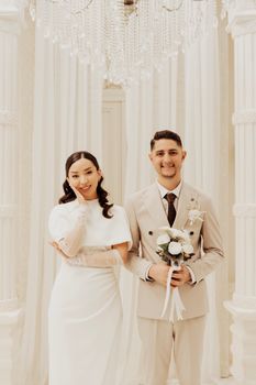 Stunning wedding portrait of a couple in a luxurious indoor setting in İstanbul, Türkiye.