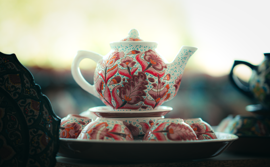 Artistic ceramic teapot with intricate floral design, captured in Samarkand, Uzbekistan.