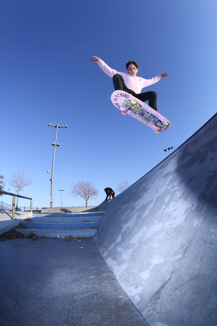 Skater Riding On Ramp In Park