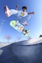 Cool black teenager doing skateboard trick