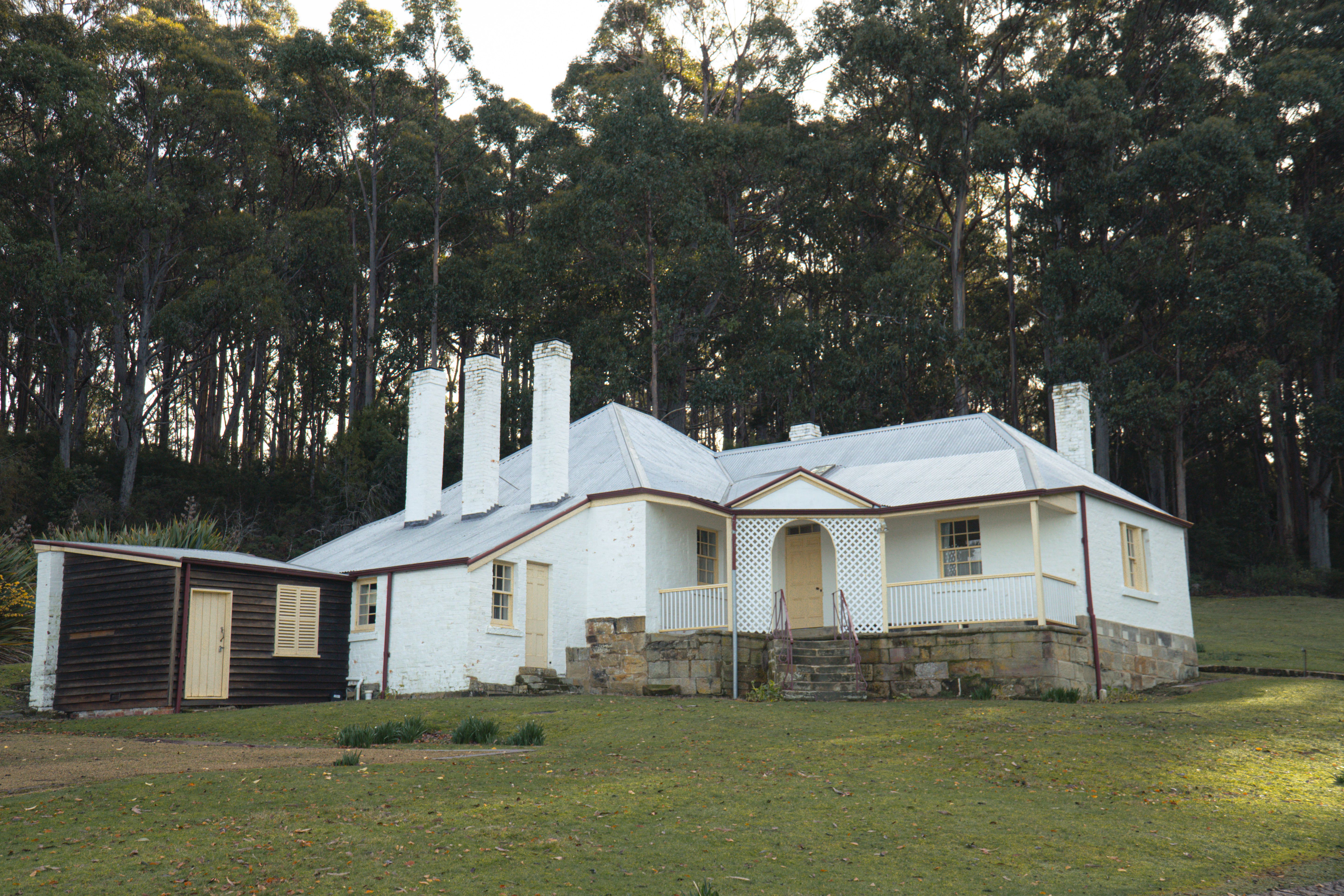 Charming historic house surrounded by lush forest in Port Arthur, Tasmania, Australia.