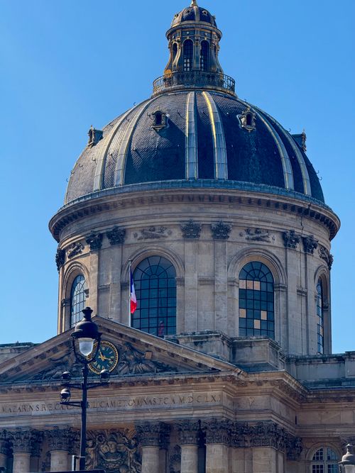 Free Elegant architecture of the Institut de France under a clear blue sky in Paris, France. Stock Photo