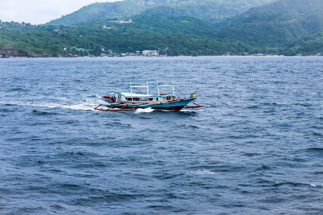 Free stock photo of blue sea, boat, green mountains Stock Photo