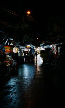 Explore the vibrant and moody atmosphere of a Vietnamese night market in Ho Chi Minh City.