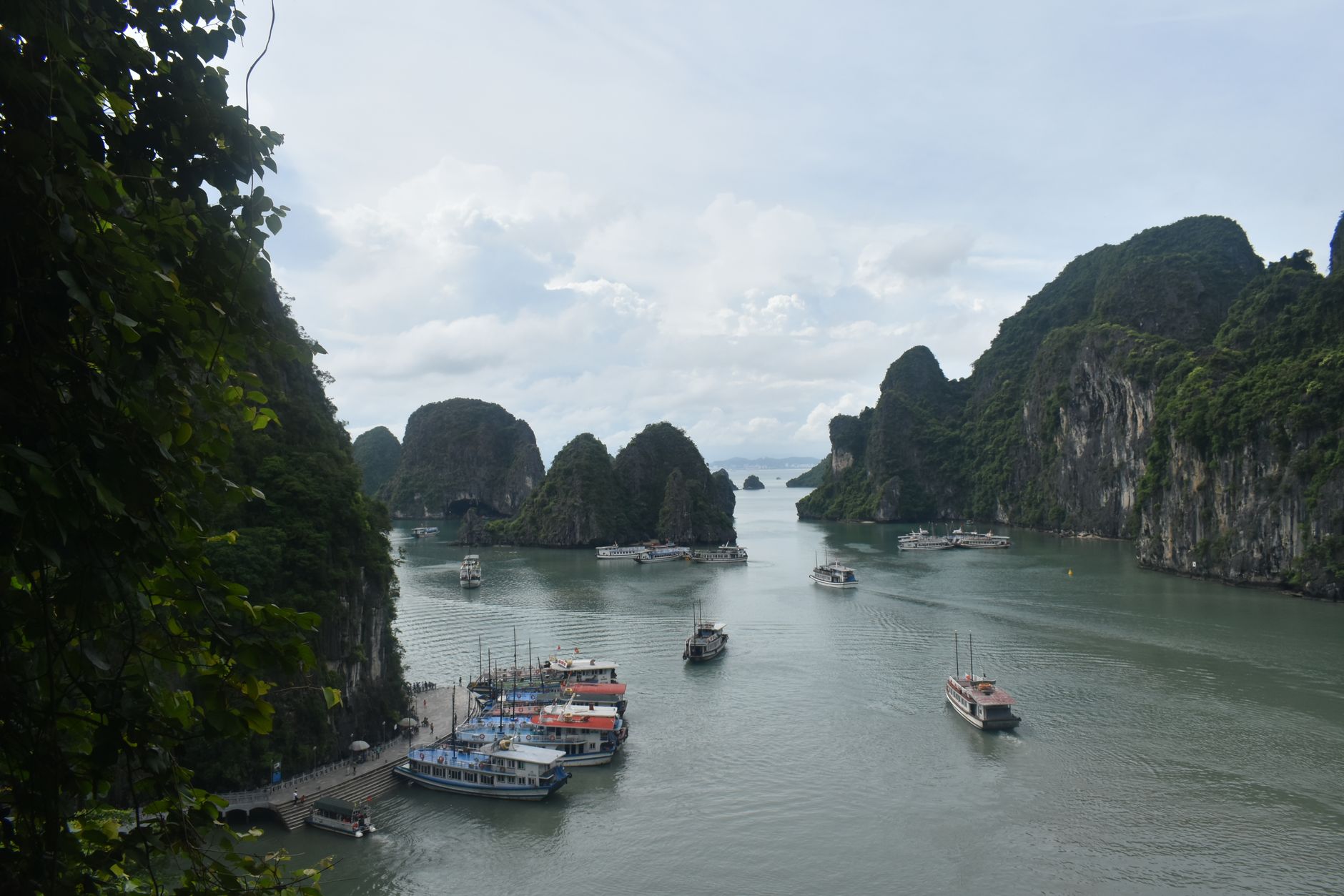 Explore the stunning limestone islands and boats in Ha Long Bay, Vietnam.