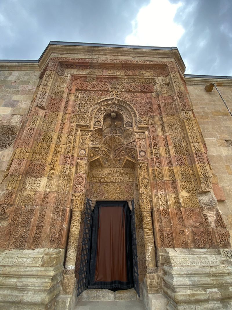 Detailed stone carvings on the portal of Divriği Great Mosque in Sivas, Türkiye, showcasing Islamic architecture.