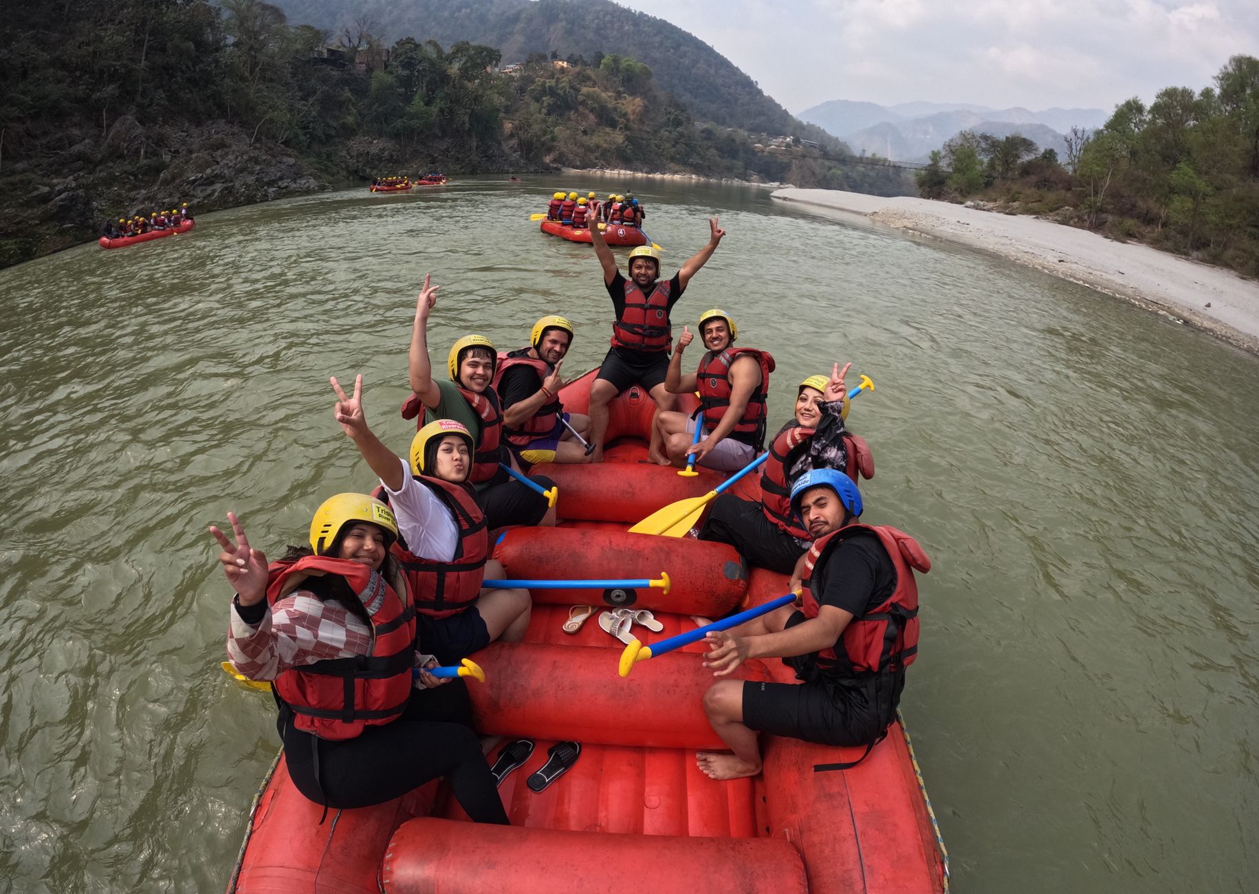Group enjoying a thrilling white water rafting experience on a scenic river.