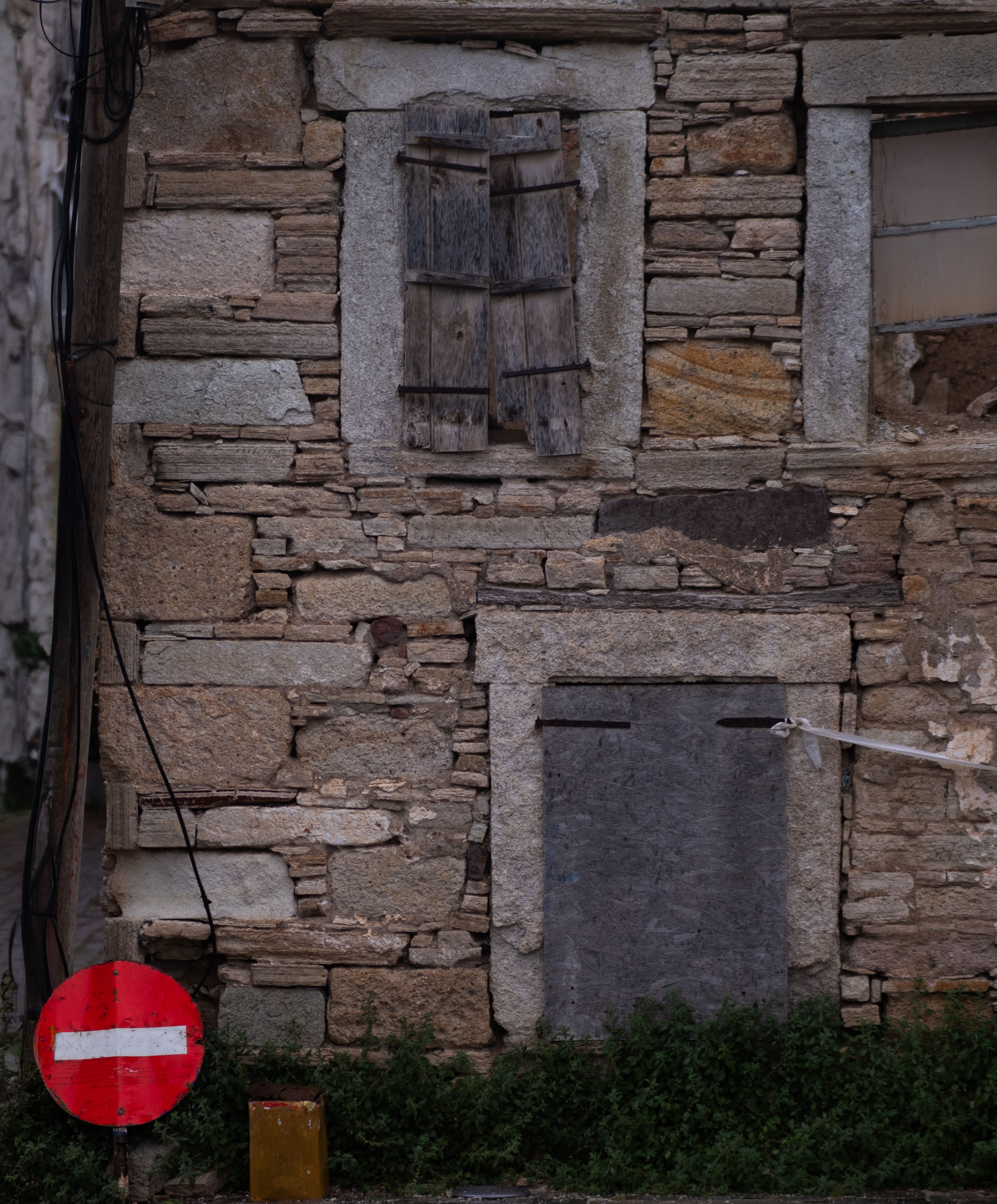 Rustic stone building and do not enter sign in Foça, İzmir.