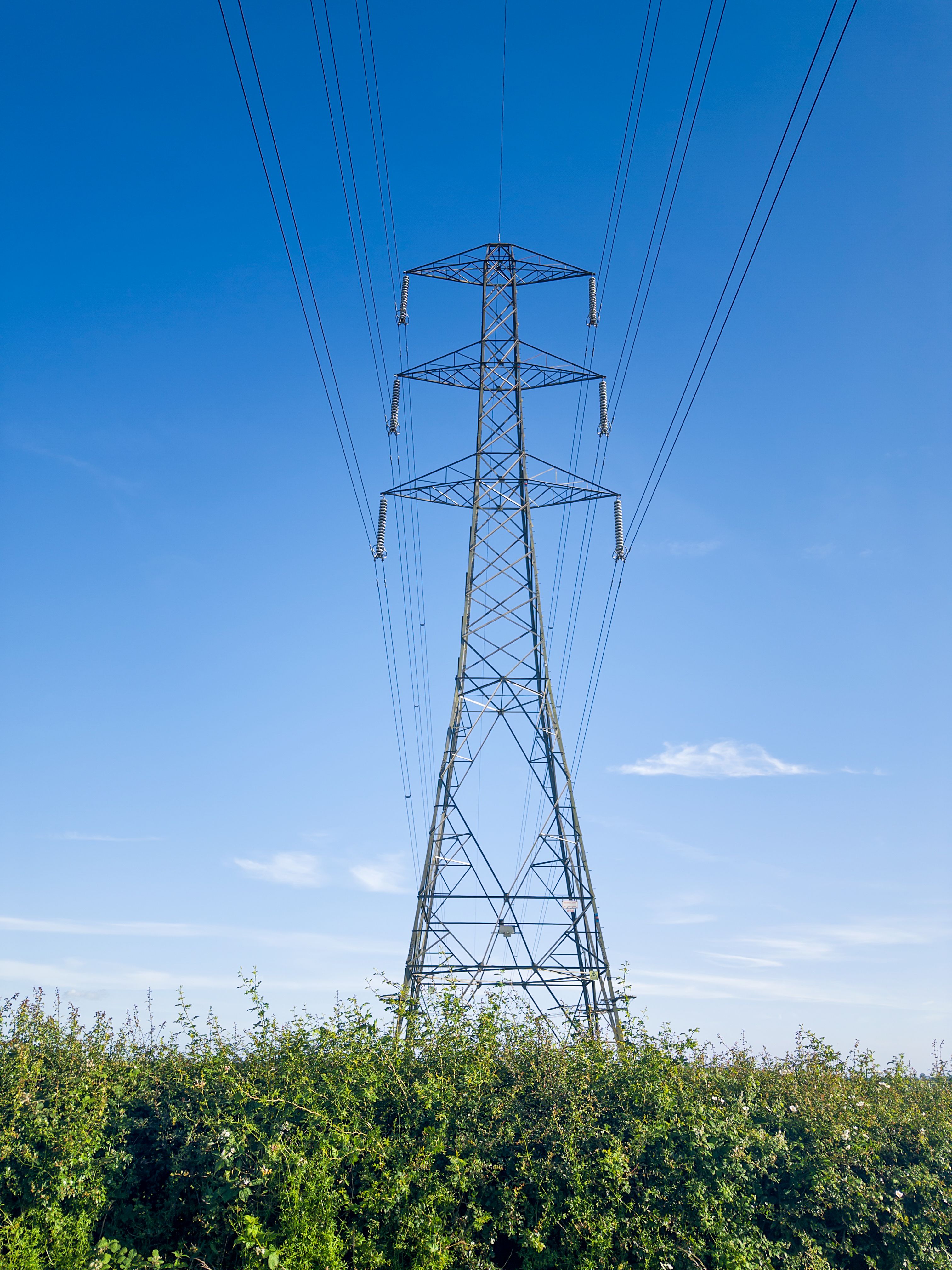 High Voltage Transmission Tower Under Blue Sky · Free Stock Photo