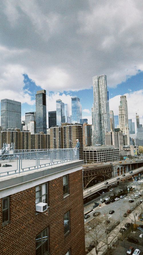 Free Stunning vantage of NYC skyscrapers from a rooftop, showcasing urban architecture. Stock Photo