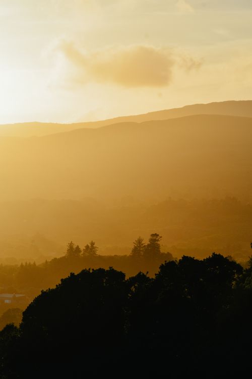 Free Captivating sunset over rolling hills in Ireland, with warm golden tones and silhouettes. Stock Photo