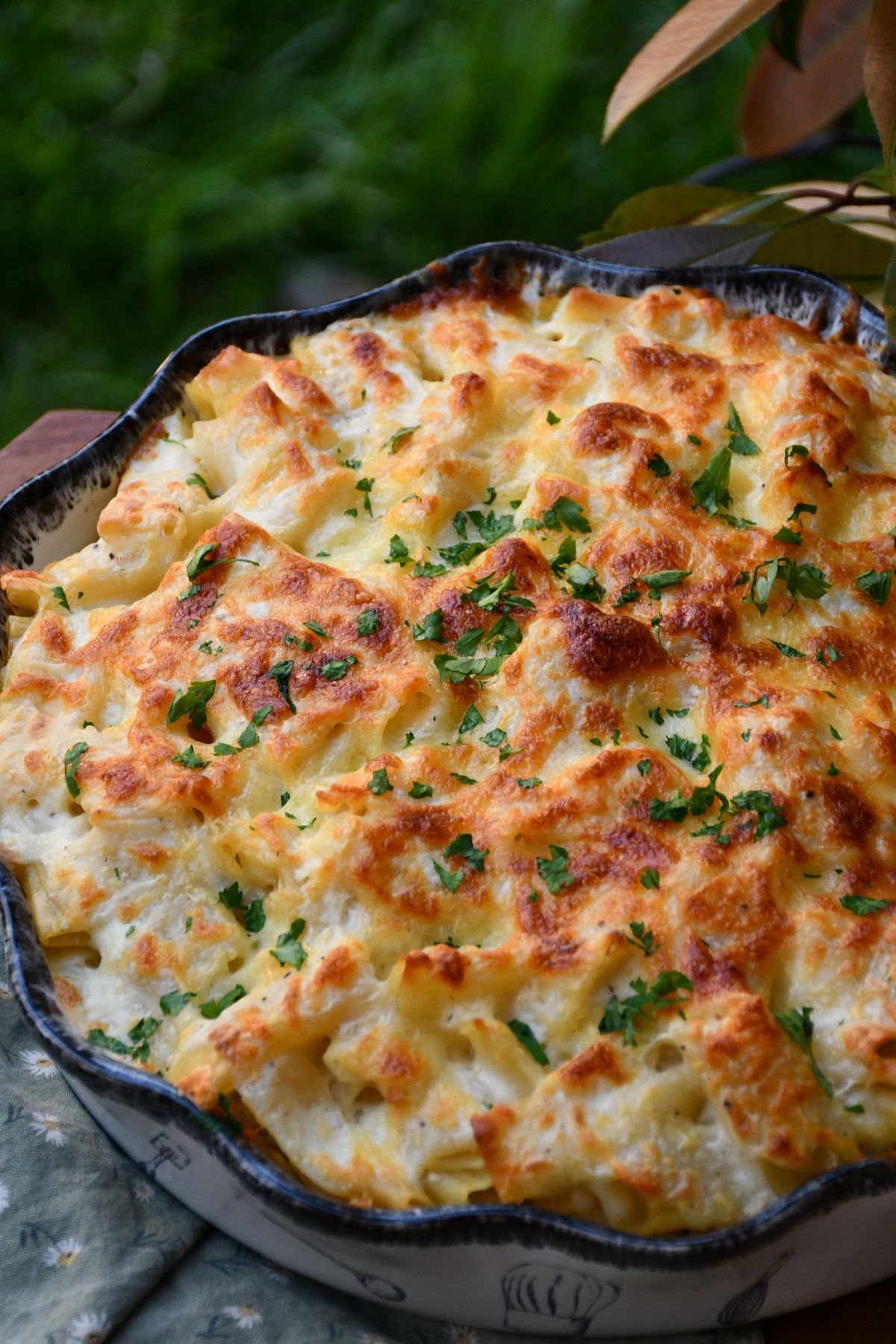 baked mac and cheese recipe garnished with fresh parsley after broiling