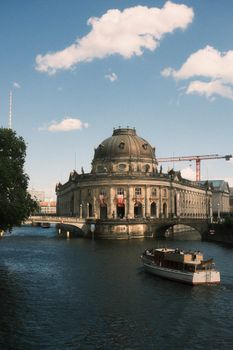 Scenic view of Bode Museum by the Spree River with a boat in Berlin, Germany.