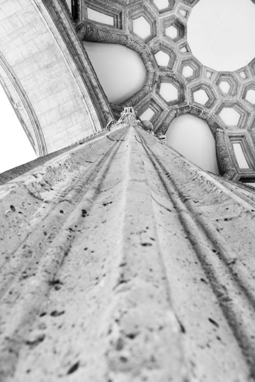 Free Black and white image of a stone column extending into a geometric ceiling pattern. Stock Photo