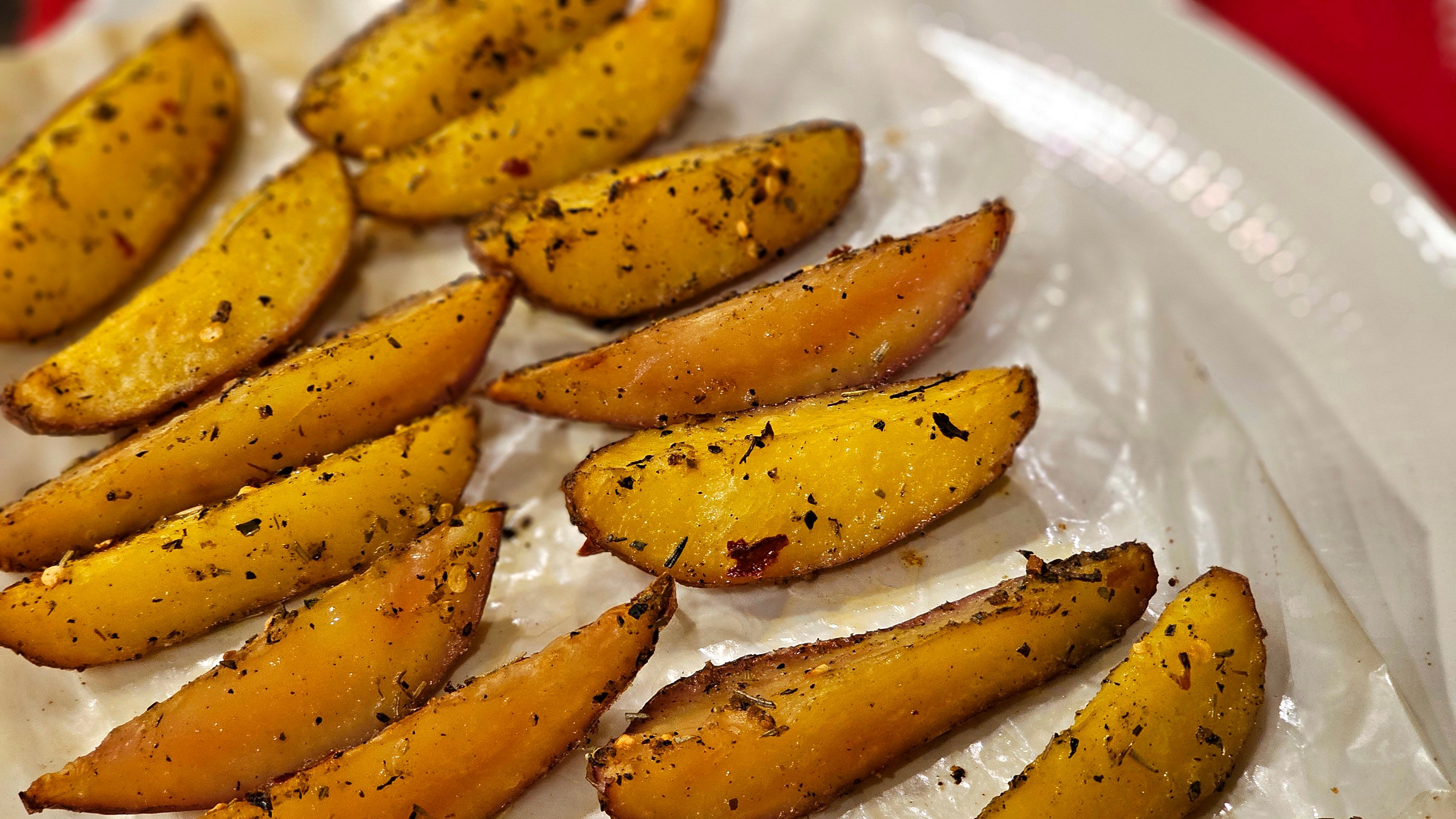 Crispy oven potatoes with fresh herbs on plate