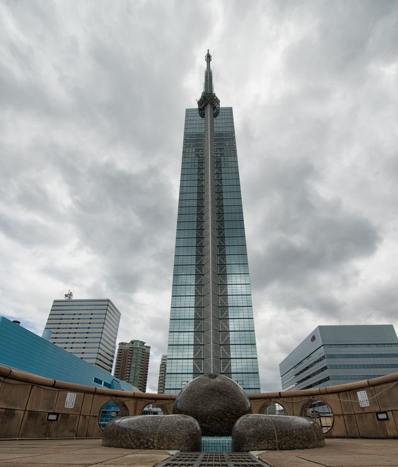 Fukuoka Tower with its geometric glass facade under dramatic skies