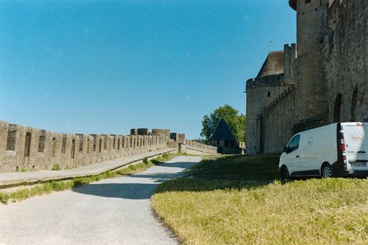 View of the historic fortifications of Carcassonne, showcasing medieval architecture under a clear blue sky.