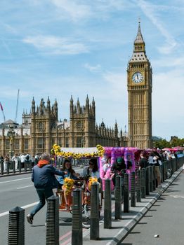 Colorful rickshaw on Westminster Bridge with Big Ben and Houses of Parliament in background.
