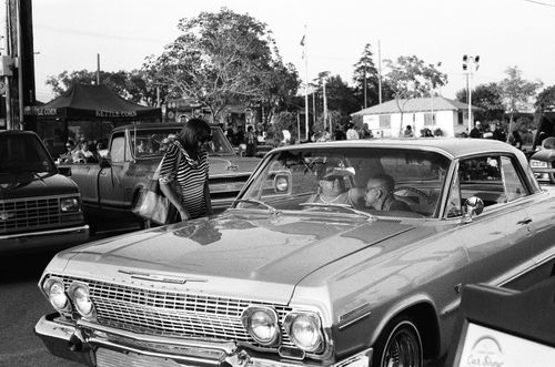 Free Black and white photo of a classic car with people at a car show in Fontana, CA. Stock Photo