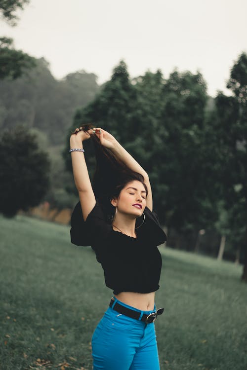 Dreamy young woman in green park