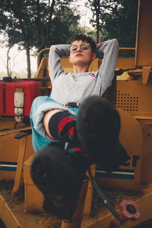 Cool informal woman on chair in countryside