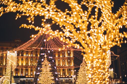 Free Vibrant display of Christmas lights and decorations at night creating a festive atmosphere. Stock Photo