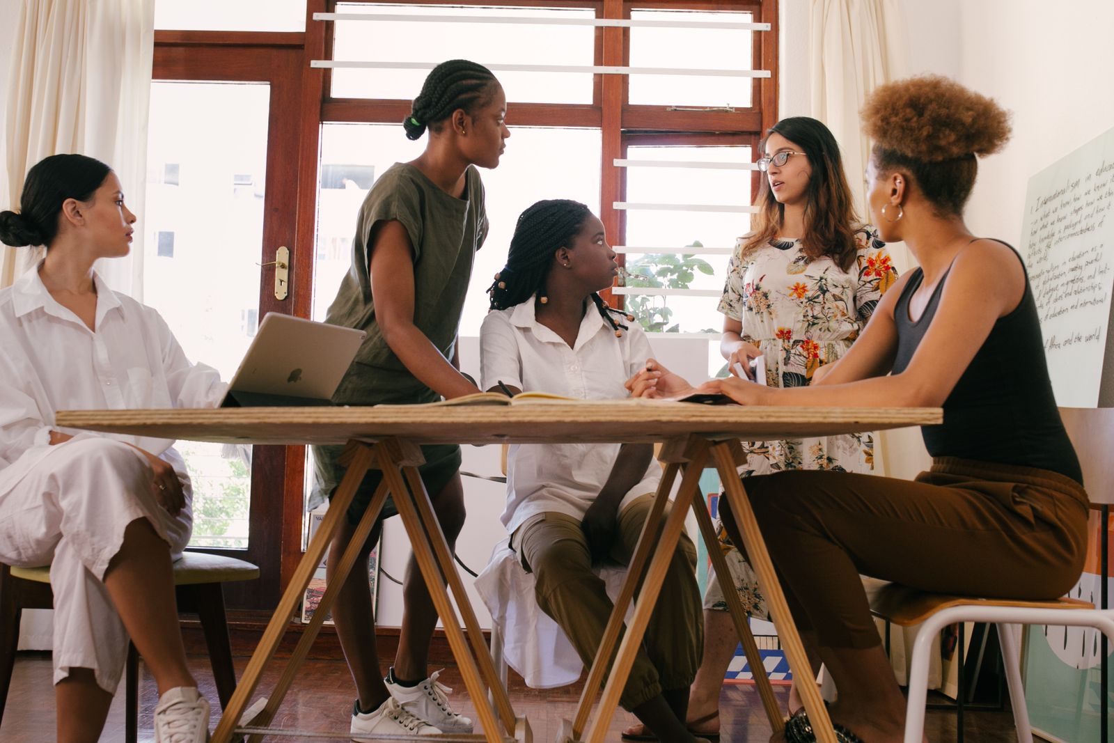 Group of women brainstorming together in a modern office