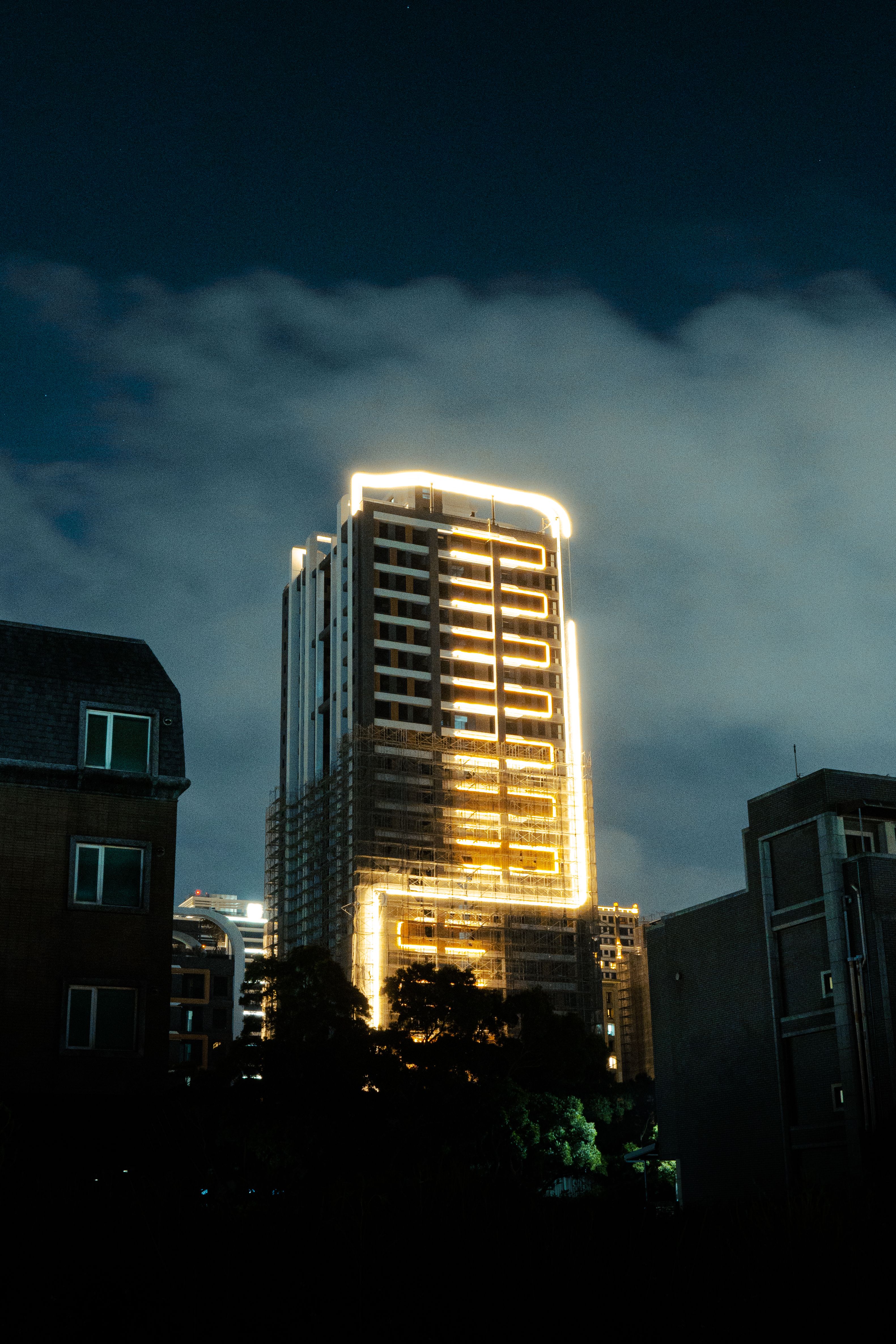 Illuminated High-Rise Building at Night · Free Stock Photo