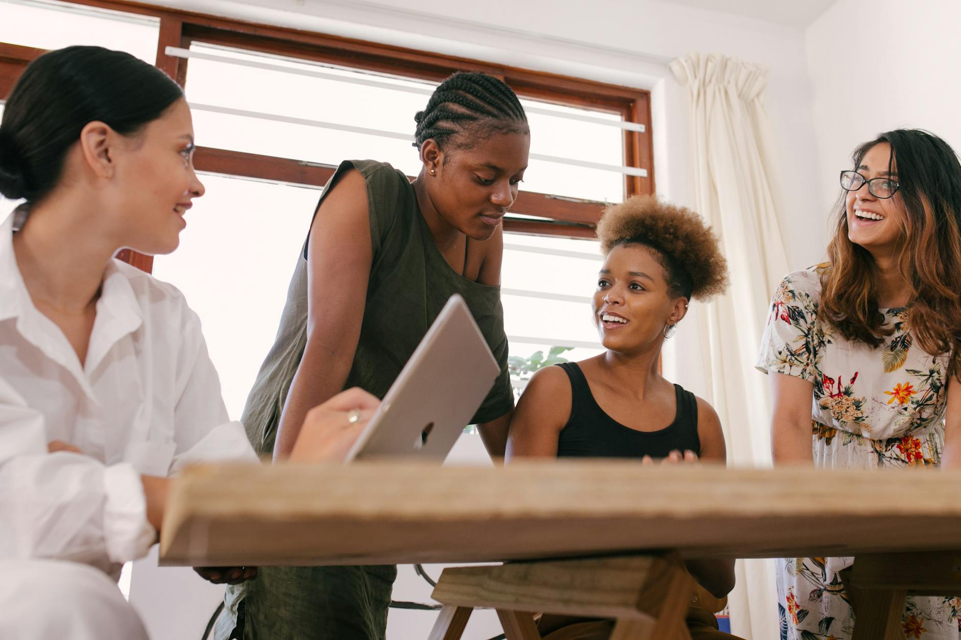 young professionals collaborating around a computer.