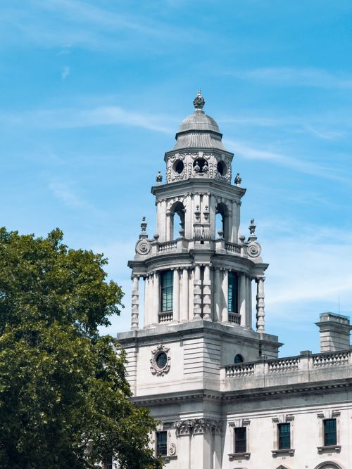 Free Capture of a historic Whitehall building with a clear blue sky backdrop, highlighting its architectural grandeur. Stock Photo