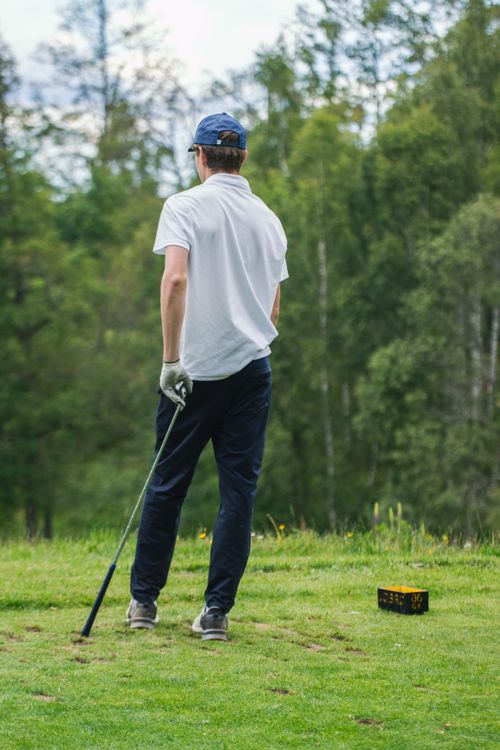Free Man golfing on green fairway surrounded by forest in Jönköping, Sweden. Stock Photo