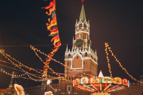Free From below festive carousel on Red Square against famous fortress Kremlin during winter holidays in evening Moscow Stock Photo