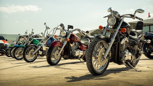Free A collection of colorful vintage motorcycles parked outdoors in Sulaymaniyah, Kurdistan Region, Iraq. Stock Photo