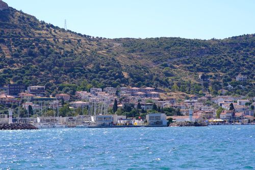 Free Beautiful coastal landscape in Foça, İzmir with harbor and lush hills. Stock Photo
