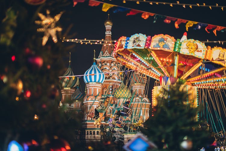 Colorful Carousel Against Cathedral On Red Square At New Year Night