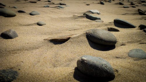 Closeup Photography of Assorted Stones on Brown Sand