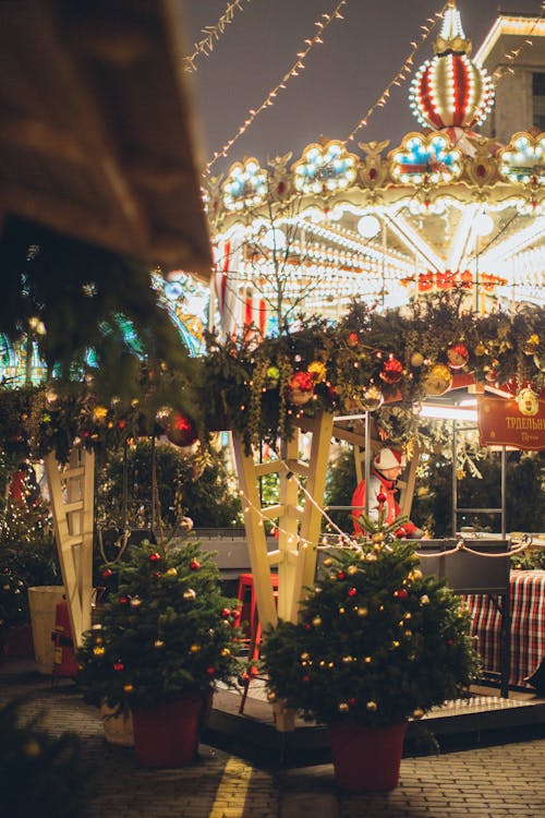 Festive merry go round decorated with sparkling lights for Christmas holidays located in amusements park in city for entertainment