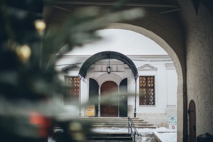 Arched Entrance Of Old Church In Winter