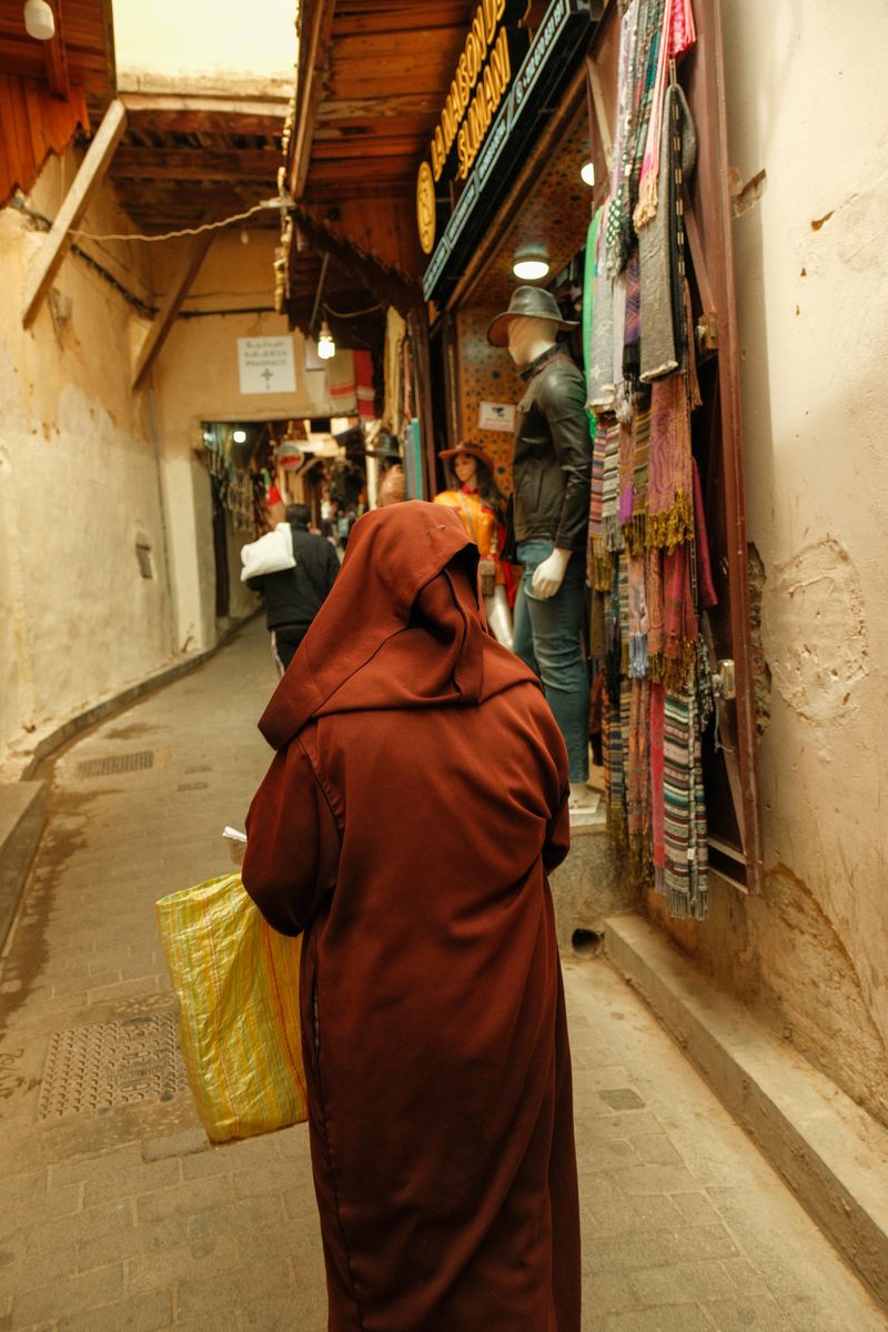 Narrow sunlit alley in the Fes medina