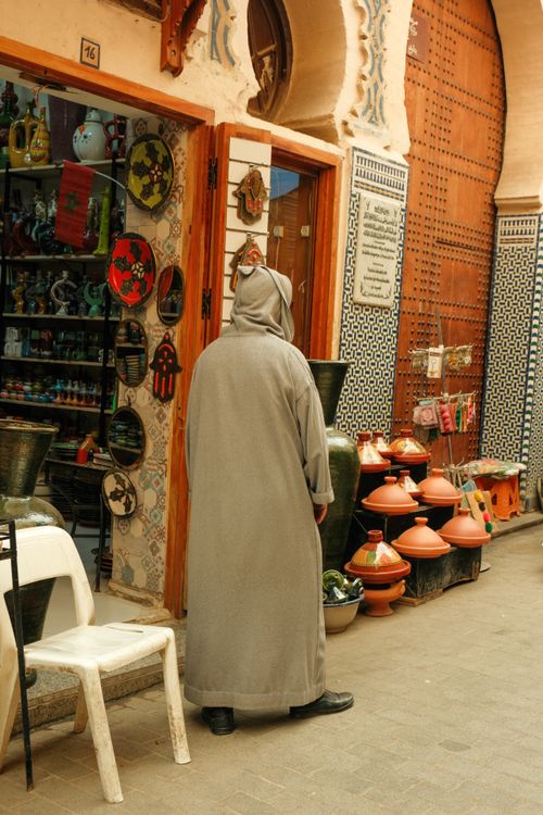 Free A person in traditional attire explores a vibrant market in Fes, Morocco. Stock Photo