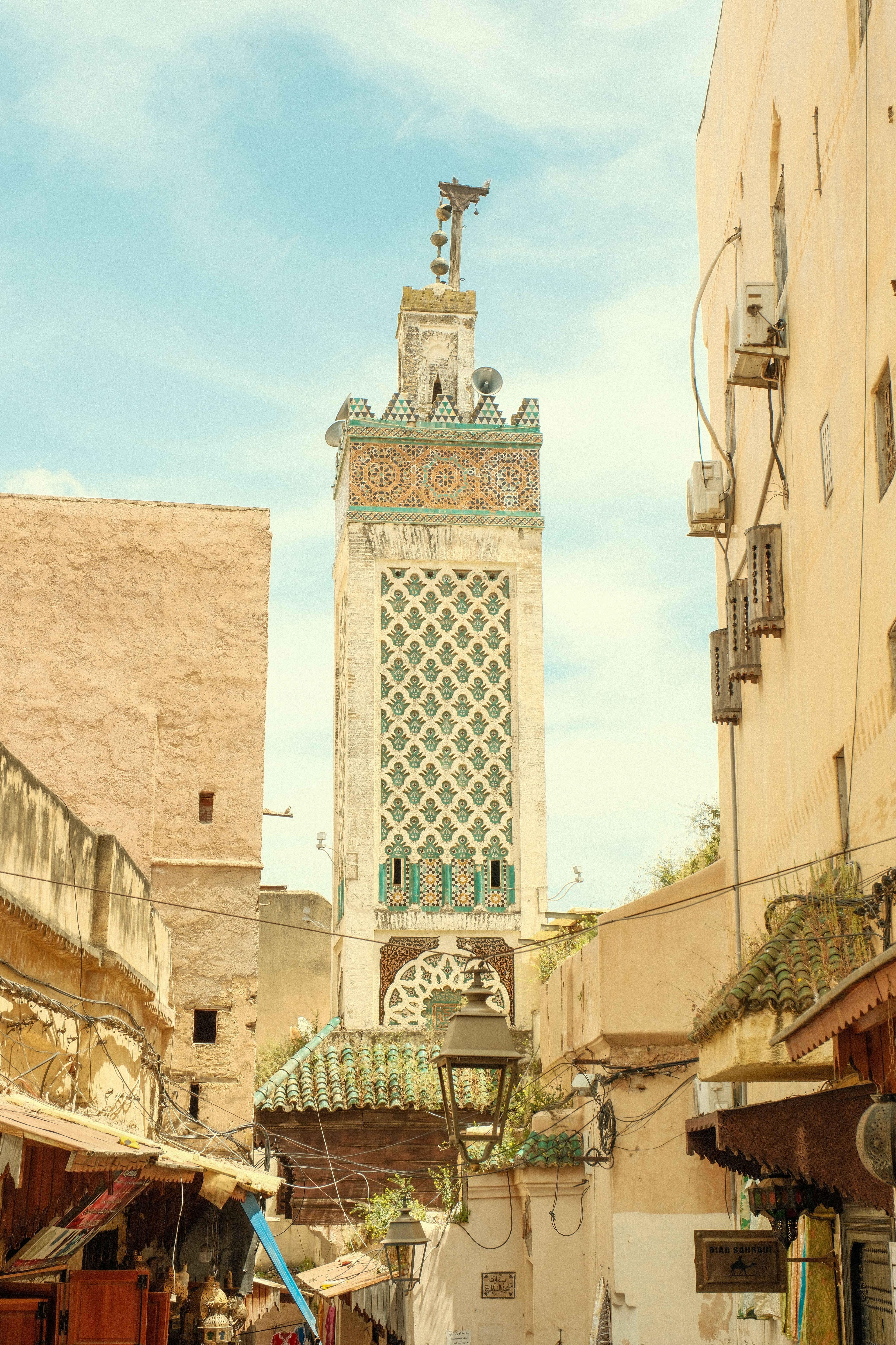 A stunning view of the Bou Inania Madrasa minaret in Fes, showcasing Moroccan architecture.