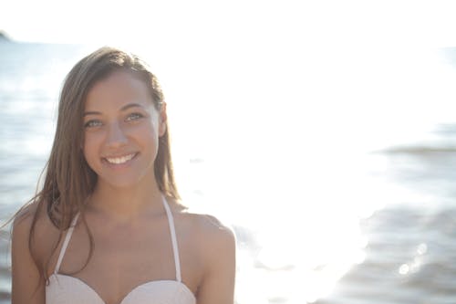 Free Woman in White Spaghetti Strap Top Smiling Stock Photo