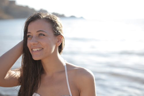 Smiling Woman in White Bikini Top