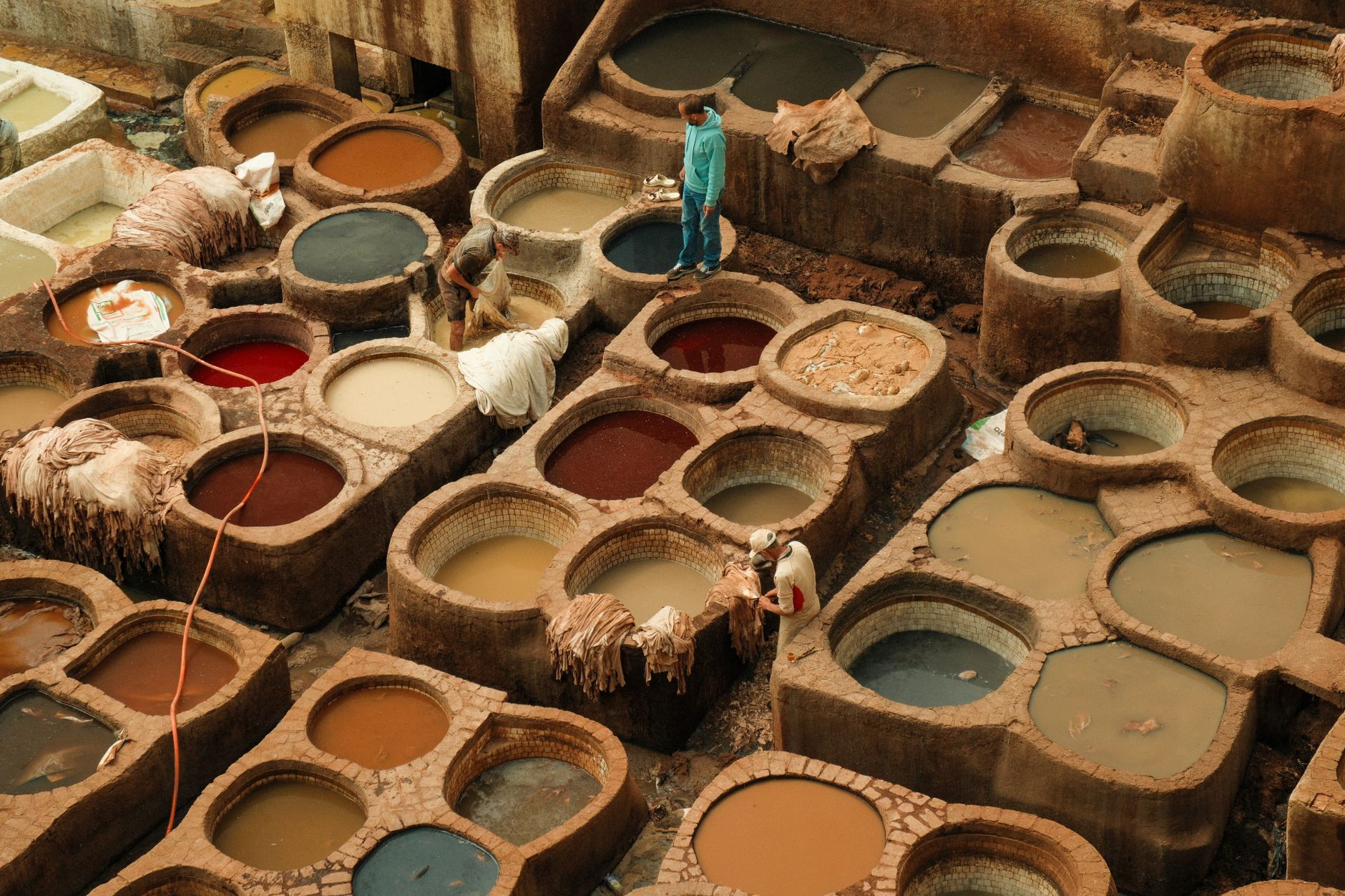 Aerial view of workers at a traditional leather tannery in Fes, Morocco.