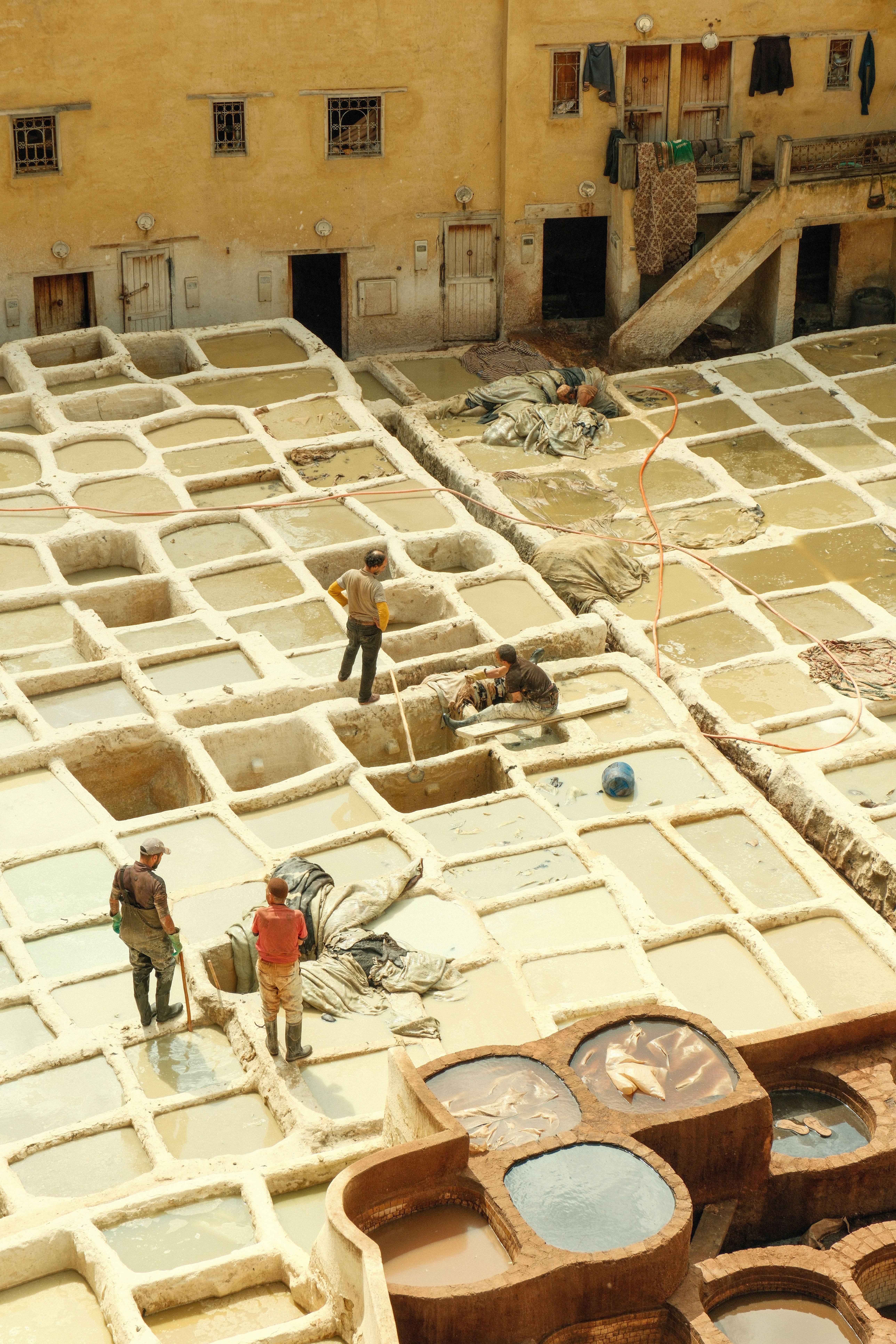 Aerial view of workers at a traditional tannery in Fes, Morocco.