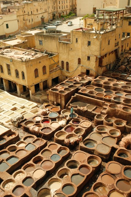 Free Aerial view of traditional leather tanneries in Fes, showcasing the ancient artisan craft under the sun. Stock Photo