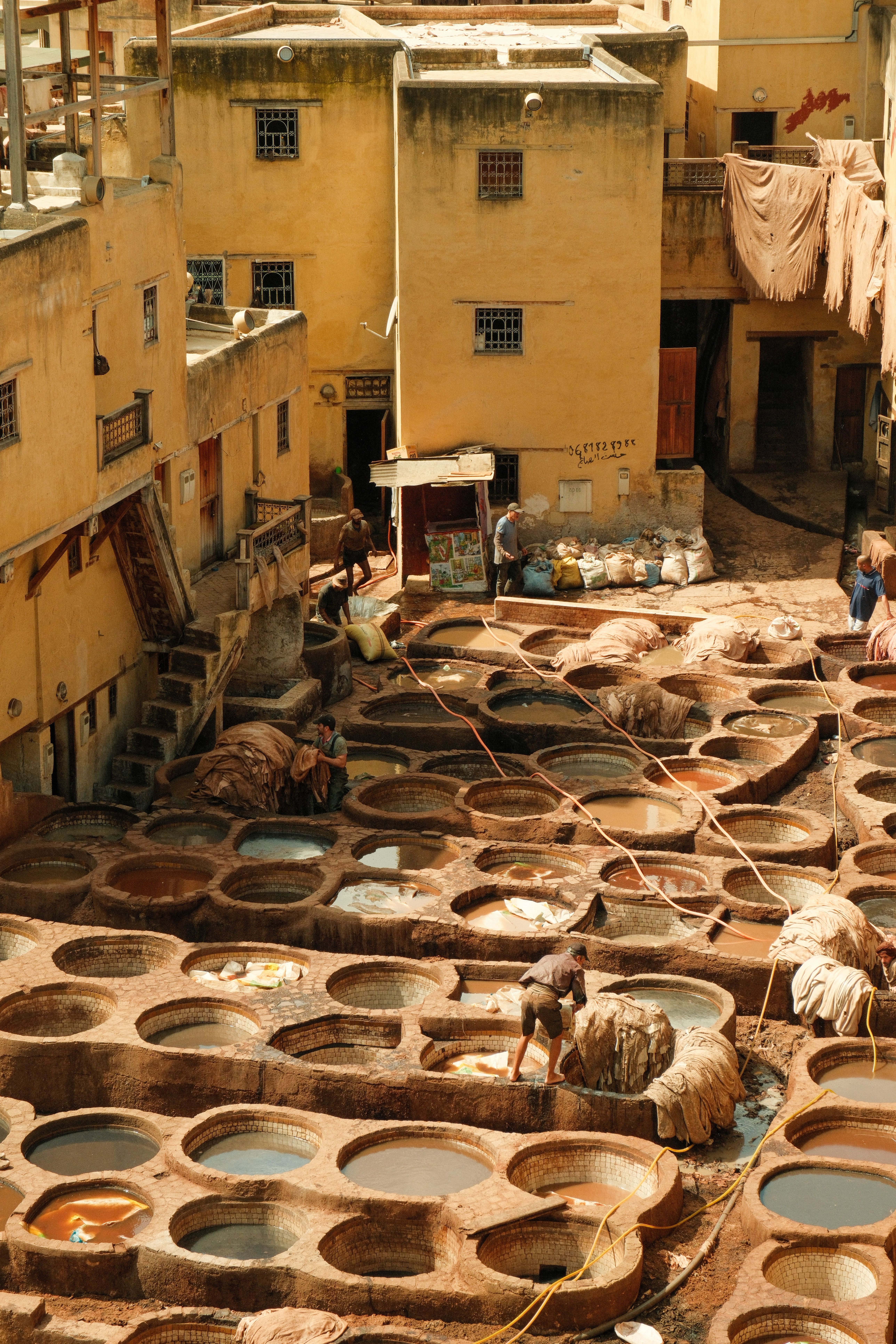 Aerial view of a traditional tannery in Fez, showcasing ancient leather dyeing vats.