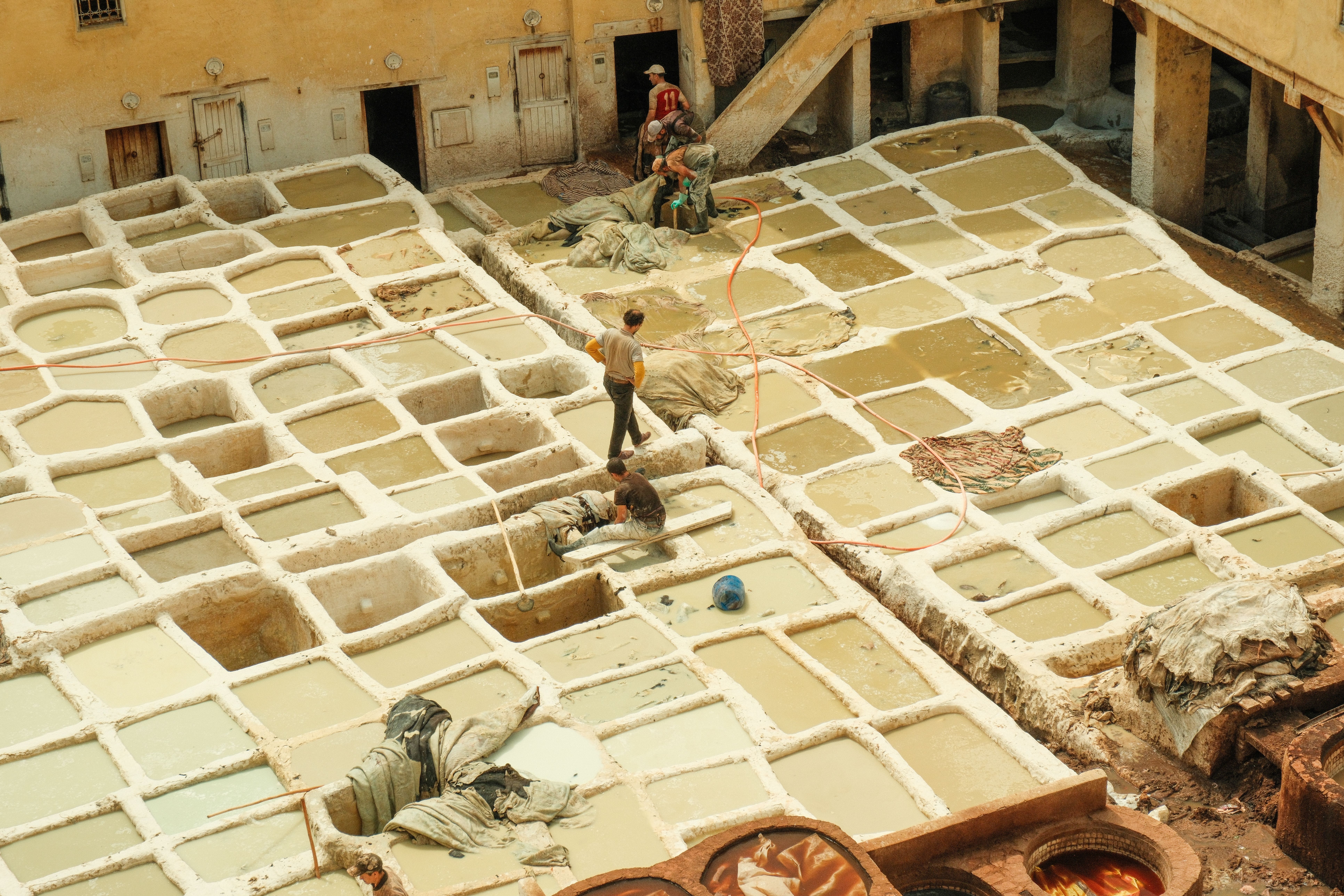 Traveler using a smartphone with Google Maps for navigation in the ancient Fes medina, Morocco
