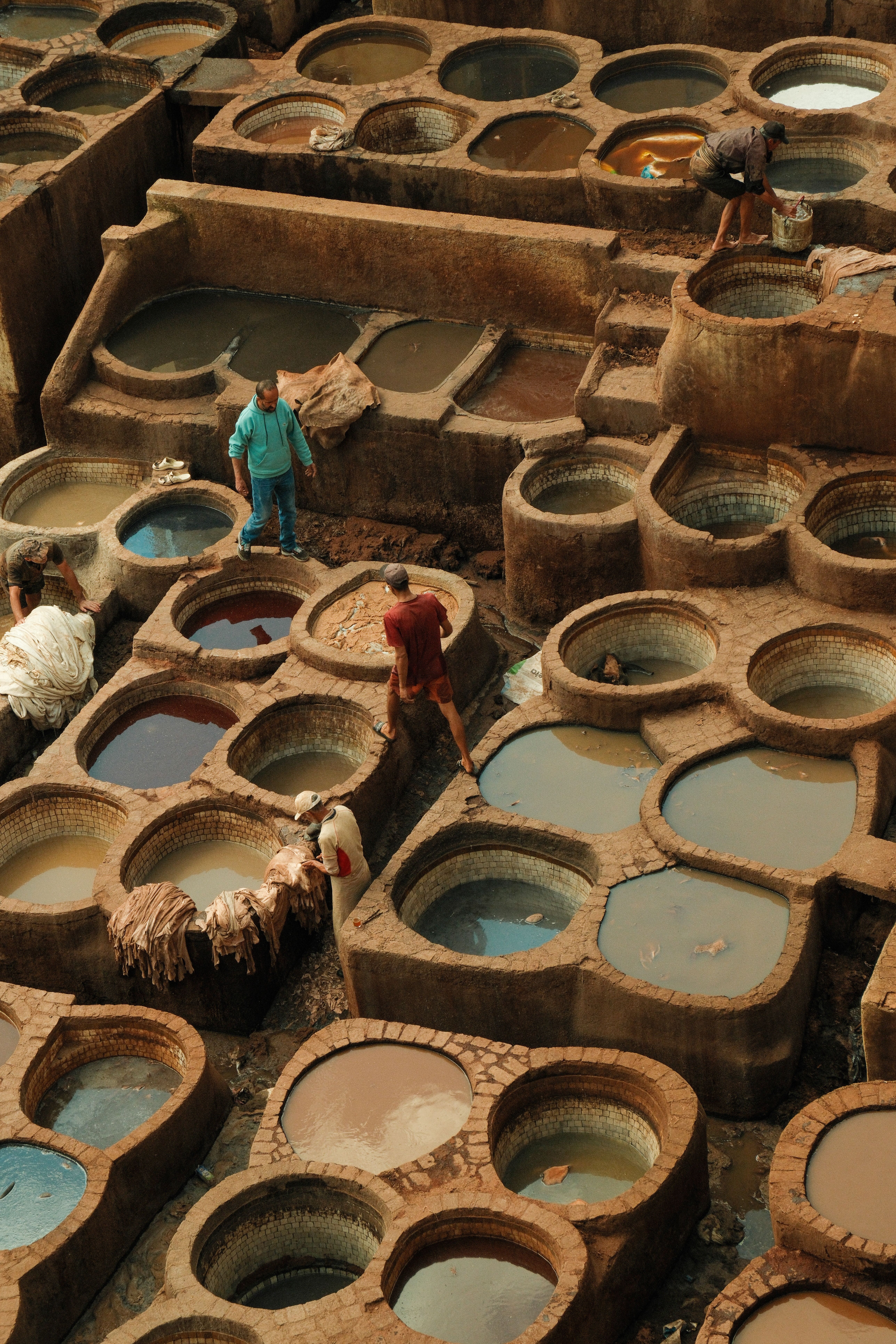View of the ancient dye pits at Fes Tannery, showing artisans at work.